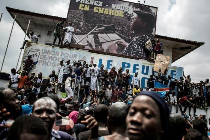 Supporters of Felix Tshisekedi, who was named provisional winner of Democratic Republic of Congo's presidential election, celebrate outside the Union for Democracy and Social Progress (UDPS) headquarters in Kinshasa on January 10, 2019