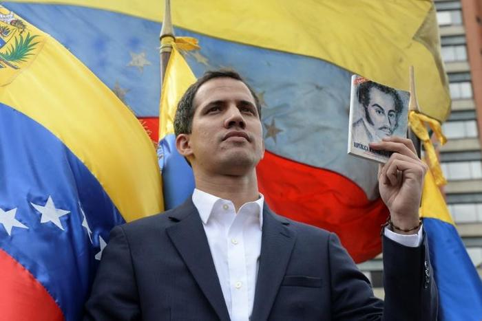 Venezuela's National Assembly head Juan Guaido declares himself the country's "acting president" during a mass opposition rally against leader Nicolas Maduro, on the anniversary of 1958 uprising that overthrew military dictatorship in Caracas on Januar...