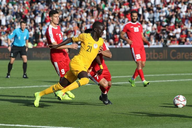 Australia's Awer Mabil scores as the Socceroos beat Palestine to keep their hopes of a last 16 place alive