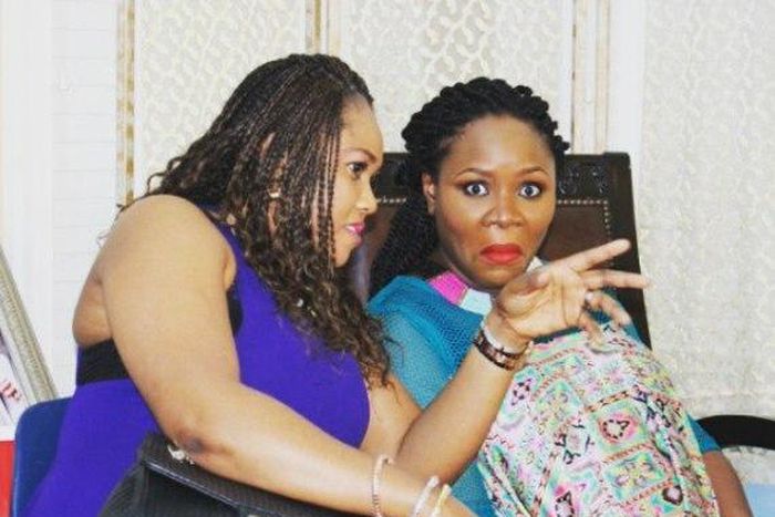 Omawumi goofing with the photographer as a friend chats her on
