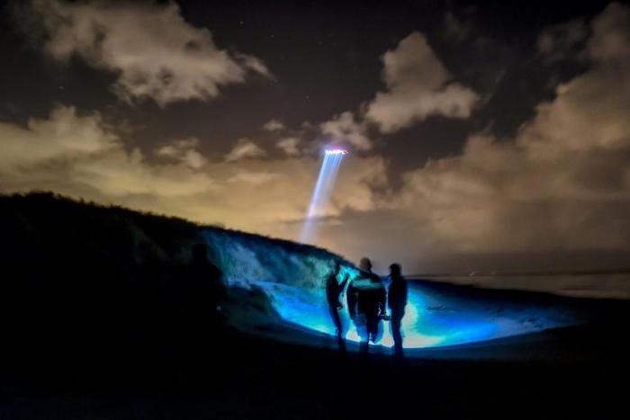 French gendarmes patrol while a police helicopter flies over the beach of Oye-Plage, near Calais, northern France, as they try to intercept migrants attempting to cross the Channel