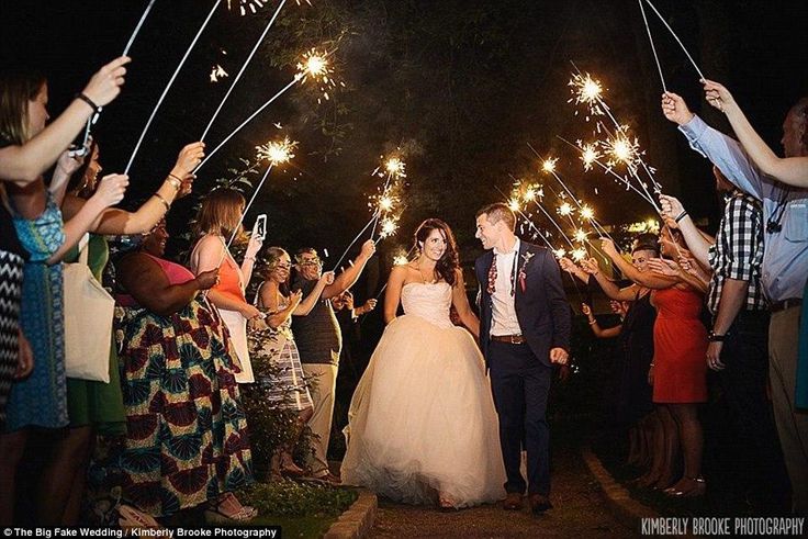 This may look like a wedding, but the bride and groom are actually renewing their vows - and the guests are engaged couples attending what has become known as The Big Fake Wedding 