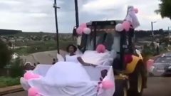 Newly wedded couple uses forklift as wedding car
