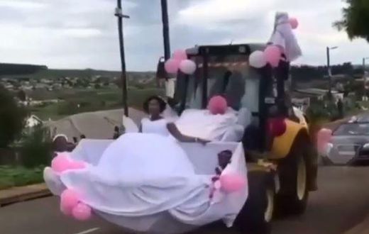Newly wedded couple uses forklift as wedding car