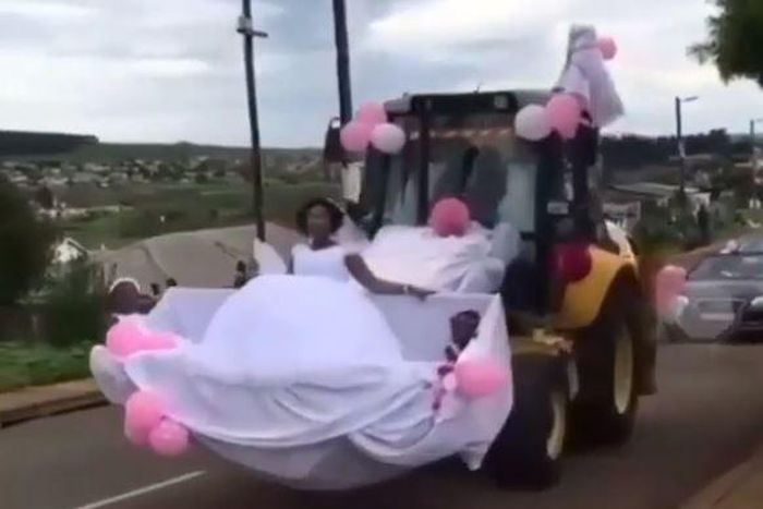 Newly wedded couple uses forklift as wedding car
