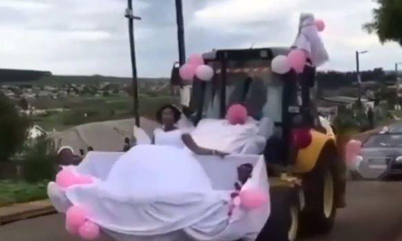 Newly wedded couple uses forklift as wedding car
