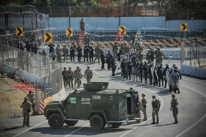US troops pictured in November 2018 at the San Ysidro border crossing, where 20 Central American asylum seekers a day are expected to be returned by the US
