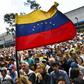 Anti-government activists listen to the president of Venezuela's opposition-led National Assembly Juan Guaido in Caracas on January 11, 2019