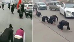 Company makes employees crawl through the streets for failing to meet sales targets (Video)