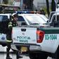 Security forces at the site of a car bombing at a police cadet training school in Bogota