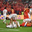 Players check-up on teammates after a collision in the Asian Cup quarter-final between China and Iran