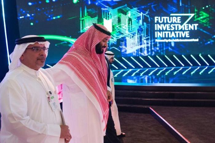 Saudi Crown Prince Mohammed bin Salman walks with Bahrain's Crown Prince Salman bin Hamad bin Isa Al-Khalifa during a major investment conference in Riyadh, in a photo provided by the Saudi palace on October 24, 2018