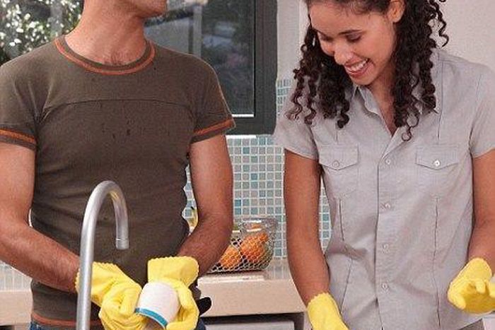 Happy couple doing chores
