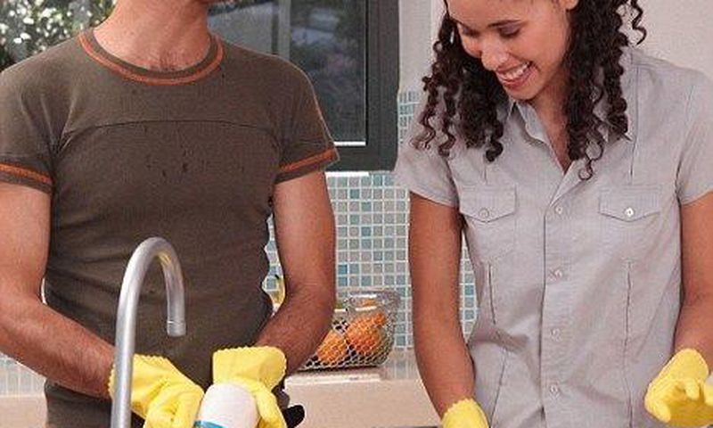 Happy couple doing chores