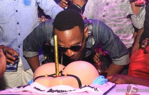 D'Banj savouring his booty on a G-string inspired birthday cake