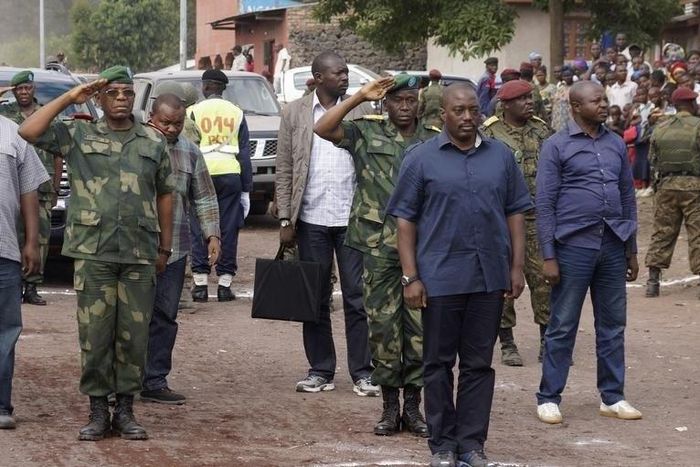 Democratic Republic of Congo's President Joseph Kabila (front C) stands for the national anthem along a street in Goma, a town in eastern Democratic Republic of the Congo, November 30, 2013. REUTERS/Kenny Katombe