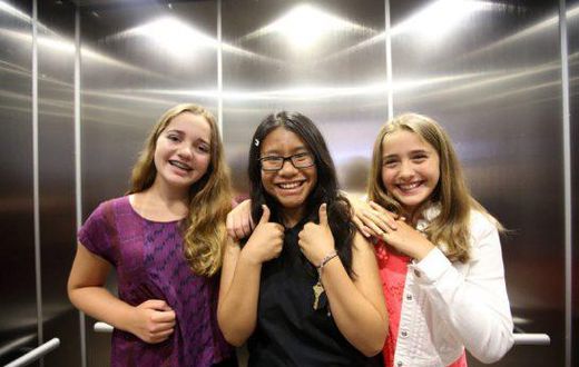 Three winners of the refugee poetry contest pose for pictures at Aki Studio Theatre in Regent Park to mark World Refugee Day.
