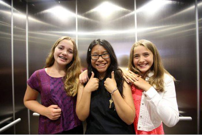 Three winners of the refugee poetry contest pose for pictures at Aki Studio Theatre in Regent Park to mark World Refugee Day.
