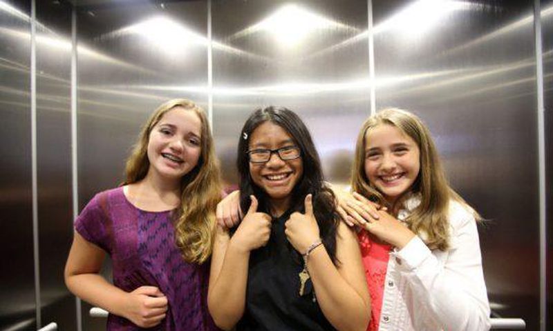 Three winners of the refugee poetry contest pose for pictures at Aki Studio Theatre in Regent Park to mark World Refugee Day.