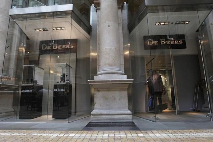 A man enters a branch of De Beers at the Royal Exchange shopping centre in the City of London August 16, 2010. REUTERS/Andrew Winning