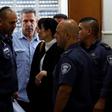 Former Israeli cabinet minister Gonen Segev, seen here being escorted from court after a July 5, 2018 hearing, has reached a plea bargain that will see him serve 11 years in prison for spying for his country's arch-foe Iran