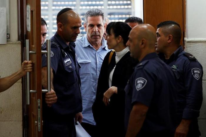 Former Israeli cabinet minister Gonen Segev, seen here being escorted from court after a July 5, 2018 hearing, has reached a plea bargain that will see him serve 11 years in prison for spying for his country's arch-foe Iran