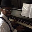 Basketmouth playing the piano
