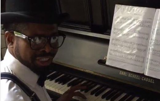Basketmouth playing the piano