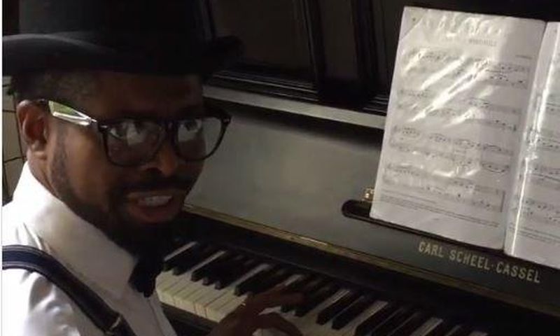 Basketmouth playing the piano