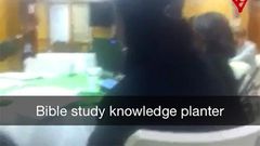 A screenshot from the video showing the killer, Dylann Roof at the far end.