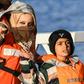 A mother and a child, part of a group of 49 migrants, react as they disembark from one of Malta's AFM Protector-class coastal patrol boats on January 9 after being transfered from the Dutch-flagged rescue Vessel "Sea Watch 3" (unseen) to Haywharf in Va...