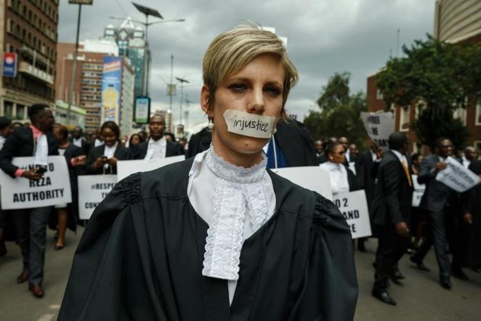 Silenced by injustice: one lawyer marched in silence with a piece of masking tape over her mouth
