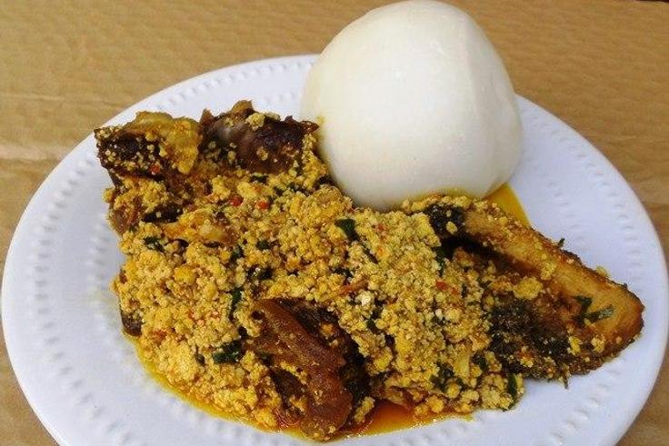 Egusi soup served in a white bowl