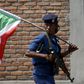 A policewoman carries a Burundi flag during a protest against President Pierre Nkurunziza's decision to run for a third term in Bujumbura, Burundi, May 29, 2015. REUTERS/Goran Tomasevic