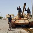 Members of the Libyan pro-government forces gesture as they stand on a tank in Benghazi, Libya, May 21, 2015. REUTERS/Stringer
