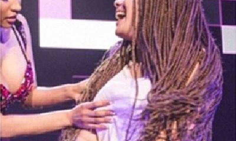 Nicki Minaj grabs a fan's burst during performance in Germany