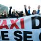 Taxi drivers blocked the road in Madrid outside one of the world's biggest tourism fairs, burning tyres and a dustbin