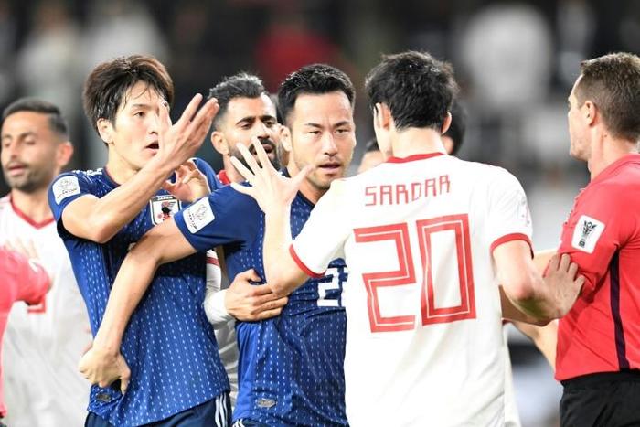 Iran forward Sardar Azmoun (2nd-R) confronts Japan midfielder Genki Haraguchi (L) during the 2019 AFC Asian Cup semi-final football match between Iran and Japan at the Hazza Bin Zayed Stadium in Al-Ain on January 28, 2019