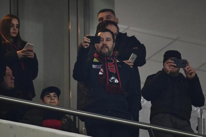 Italy's Interior Minister and Deputy Prime Minister Matteo Salvini (C) is a passionate AC Milan fan.