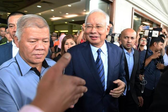 Former Malaysian prime minister Najib Razak (C) has been arrested and charged over the 1MDB scandal since being ejected from office