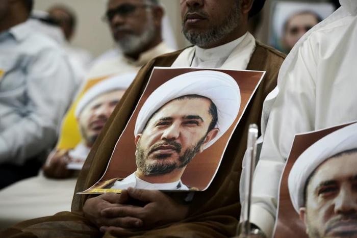 A Bahraini man holds a picture of Sheikh Ali Salman, head of the Shiite opposition movement Al-Wefaq, during a protest on May 29, 2016 against his arrest