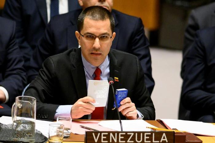 Venezuelan Foreign Minister Jorge Arreaza shows the Charter of the United Nations and the Constitution of Venezuela as he speaks to the United Nations Security Council