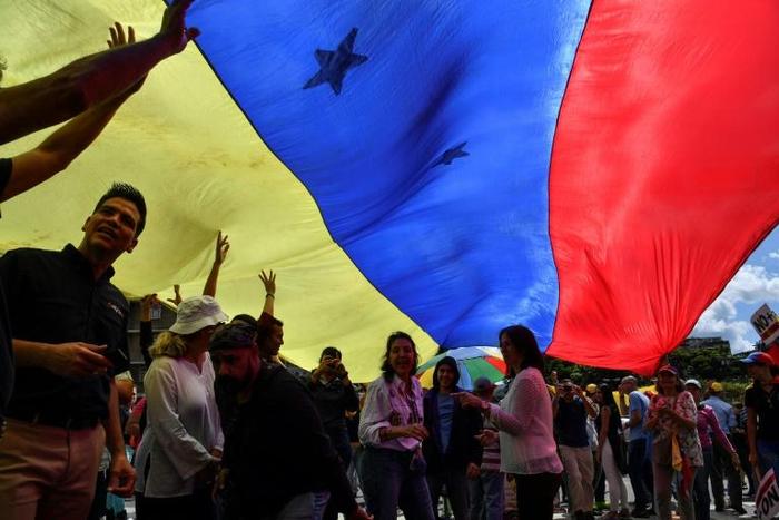Opposition demonstrators rally in Caracas against President Nicolas Maduro, ordered the United States to pull its diplomats out of Venezuela