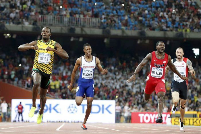 Usain Bolt of Jamaica (L) crosses the finish line ahead of Justin Gatlin (2nd R) from the U.S., Zharnel Hughes of Britain (2nd L) and Ramil Guliyev of Turkey in the men's 200m final during the 15th IAAF World Championships at the National Stadium in Be...