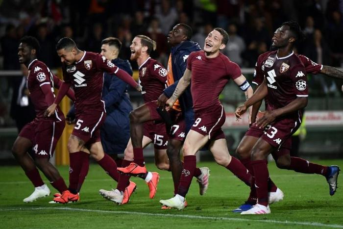 What a win: Torino's players celebrate after their 2-0 win over AC Milan