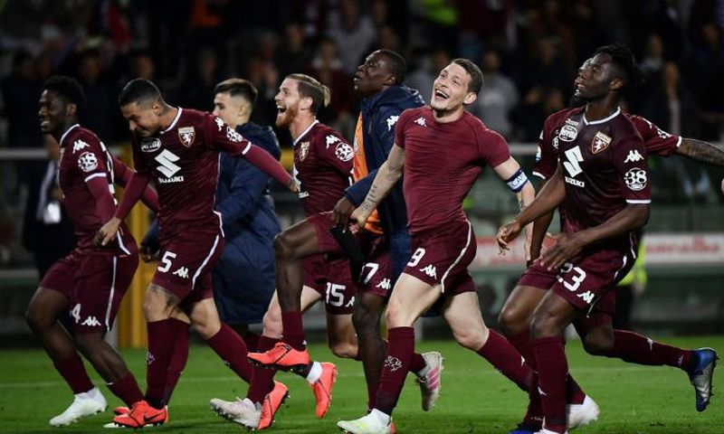 What a win: Torino's players celebrate after their 2-0 win over AC Milan
