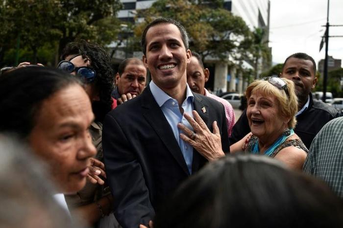 Venezuelan opposition leader and self declared acting president Juan Guaido greets supporters at a demonstration called by supporters in the transportation sector, in Caracas on February 20, 2019