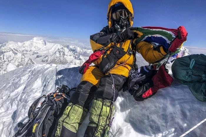 Saray Khumalo poses with a South African flag on May 16, 2019, after becoming the first black African woman to climb Mount Everest