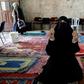 A Palestinian woman prayers at the Golden Gate building, in the Al-Aqsa mosque compound, on March 7, 2019