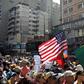 A US flag is seen amid the crowd of supporters of Venezuelan opposition leader Juan Guaido, as people start gathering for a rally to press the military to let in US humanitarian aid, in Caracas on February 12, 2019